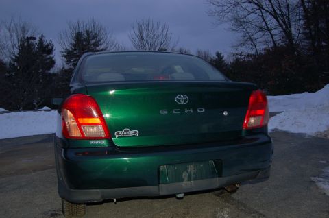 2001 Toyota Echo - Rear view of a green 2001 Toyota Echo sedan parked outdoors in winter.