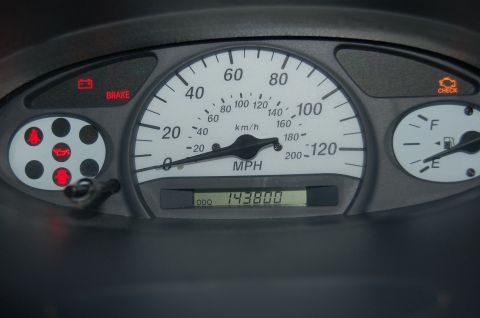 2001 Toyota Echo - The car's interior shows a dashboard with a speedometer, odometer, and illuminated warning lights.