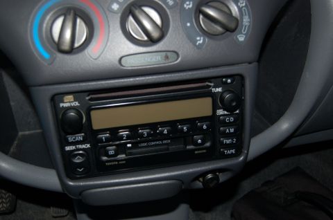 2001 Toyota Echo - Close-up of a car's interior dashboard, focusing on the radio and climate control knobs.