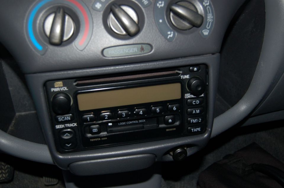 Toyota factory CD and cassette radio with rotary HVAC controls in a gray center stack