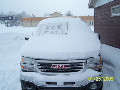 1900 Acura CL - A GMC truck is buried in snow with a 'FOR SALE' sign on its windshield.