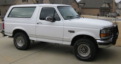 1996 Ford Bronco - Side view of a white 1996 Ford Bronco with a bull bar on the front bumper.