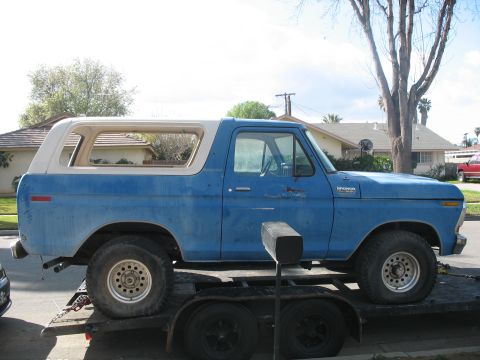 1987 Ford Bronco - This blue Ford Bronco is seen on a trailer, its side profile clearly visible. The body style indicates it is likely a 1978 model.