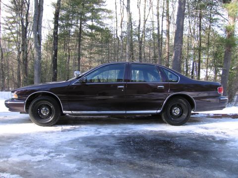 1991 Ford LTD Crown Victoria - This 1994 Chevrolet Caprice sedan is seen from the side, parked outdoors in a snowy environment.