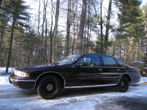 1991 Ford LTD Crown Victoria - 1996 Chevrolet Caprice sedan parked on a snowy driveway.