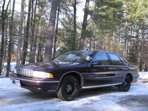 1991 Ford LTD Crown Victoria - This Chevrolet Caprice is parked in a wooded area during winter, with snow on the ground.