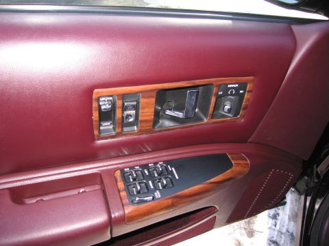 1991 Ford LTD Crown Victoria - Interior door panel with wood trim and power window controls.