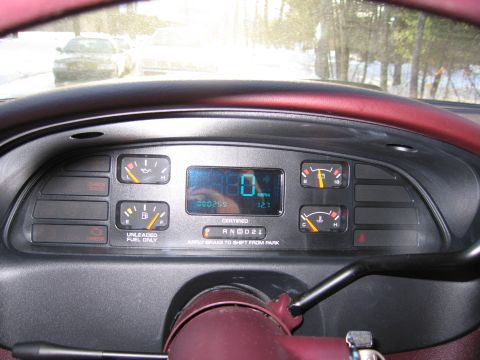 1991 Ford LTD Crown Victoria - The dashboard displays the odometer reading and gear selection, with a view of the road ahead.