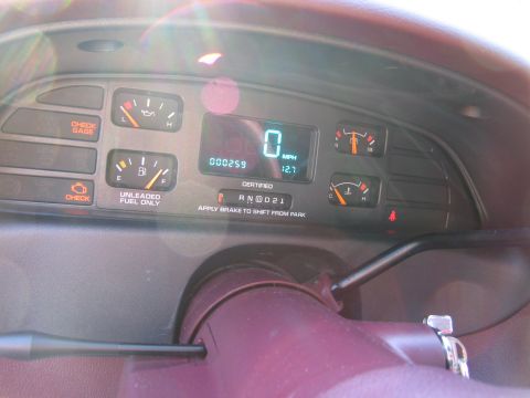 1991 Ford LTD Crown Victoria - The dashboard displays analog gauges and a digital speedometer, with the car in park and the engine off.