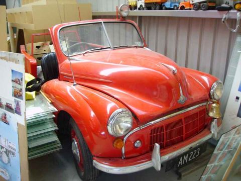 1969 MINI Cooper - This red Morris Minor features a distinctive bell mounted on its front grille and displays the license plate AM 223.