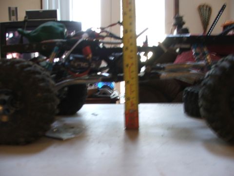 1996 Ford Bronco - The chassis of a remote control rock crawler is shown with a measuring tape for scale.