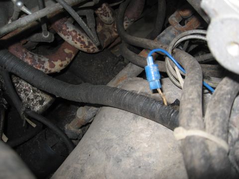 1989 Ford Bronco - Close-up of engine wiring harness showing a blue connector with exposed wire.