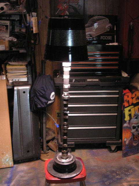 1995 Ford Bronco - Custom lamp made from engine parts, including a camshaft and brake rotor, in a workshop setting.