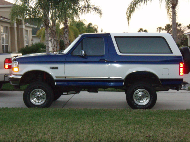 Side view of a lifted 1996 Ford Bronco in blue and white