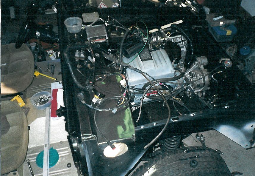 Even the Crown Vic plenum comes close to the hood, and I had to flip the IAC and move a throttle body heater line to fit the IAC around the master cylinder.  But it all works perfectly, and uses mostly stock parts that he'll be able to find at any parts store, dealership, or JY.