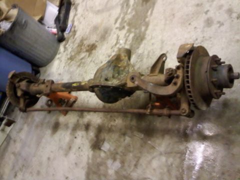 1979 Ford F-150 - This is a front axle assembly, likely for a truck, with visible rust and wear.