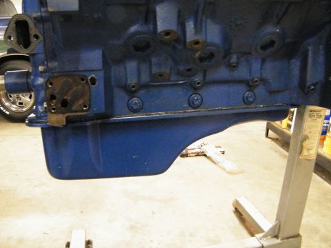1968 Mercury Cougar - Engine block and oil pan assembly on an engine stand, with a car wheel visible in the background.