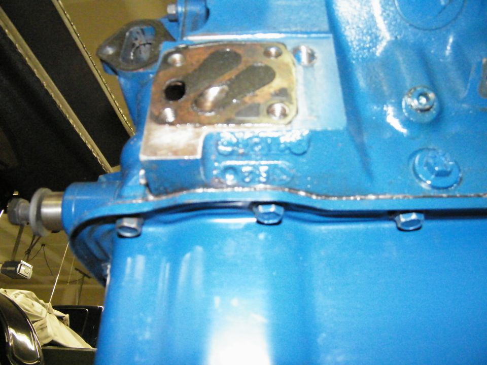 Close-up of a blue Ford V8 block casting pad above the oil pan rail