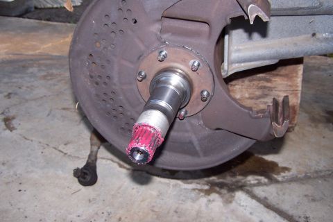 1990 Ford Bronco - Wheel hub assembly with red grease on the spindle, likely before installation or maintenance.