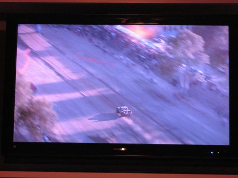 1986 Ford Bronco - A blurry off-road vehicle races on a dirt track during an event.