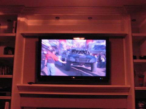 1986 Ford Bronco - A television displays a front view of an off-road truck, possibly from a race event.