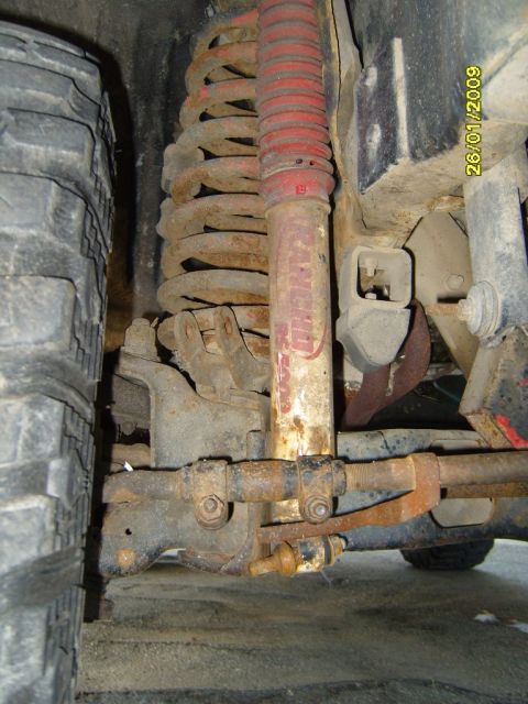 1989 Ford Bronco - The front suspension system of a vehicle, showing the tire, coil spring, and shock absorber, with a date stamp of 26/01/2009.