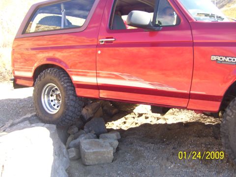 1993 Ford Bronco - This red Ford Bronco is shown off-roading over a rocky terrain, with a date stamp of 01/24/2009.
