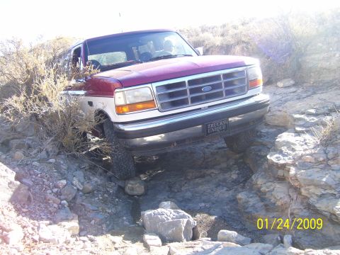 1993 Ford Bronco - This 1993 Ford Bronco navigates a rocky trail, its front grille and headlights.