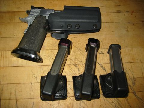 1996 Ford Bronco - A pistol, holster, and three magazines are laid out on a wooden surface.
