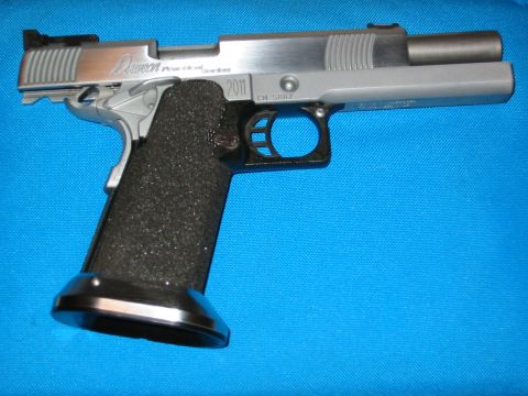 1996 Ford Bronco - A silver pistol with a textured black grip and a prominent 2011 marking on its slide.