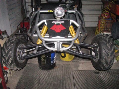 2006 Ford F1 - This go-kart features a distinctive red wolf logo on its front, along with prominent yellow suspension springs.