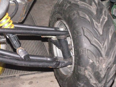 2006 Ford F1 - Close-up view of a go-kart's front suspension and tire assembly.