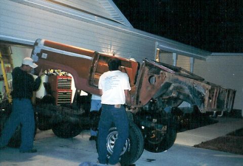 1975 Ford Bronco - Frank (driver's door) & I (passenger door) are bearing most of the weight to lift it over the engine.