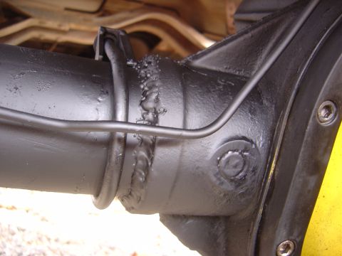 1996 Ford F-250 - Close-up view of a vehicle's rear axle housing, showing mechanical components and welding details of its construction.