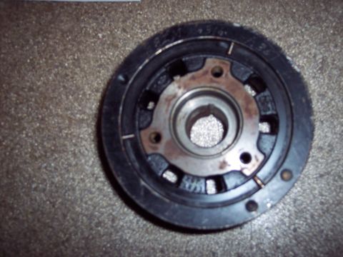 1971 Ford Mustang - Close-up of a crankshaft pulley, showing some wear and markings on its surface.
