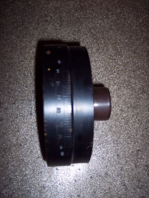 1971 Ford Mustang - Close-up of a black cylindrical part with etched measurement markings and a brown knob.