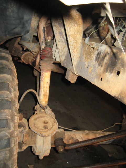 1978 Ford Bronco - Close-up view of a vehicle's suspension and drivetrain components, showing significant rust.
