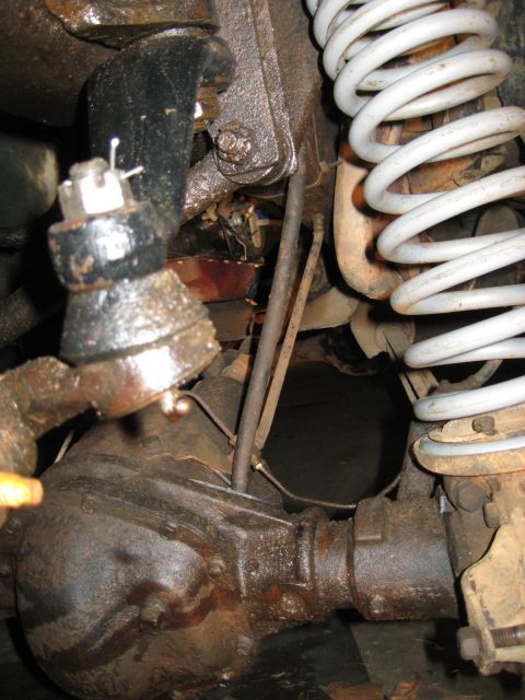 1978 Ford Bronco - Close-up view of the front differential and suspension system, including a white coil spring.
