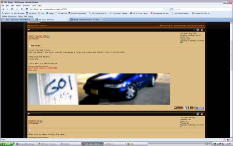 1993 Ford Taurus - A blue sedan is pictured next to graffiti that reads 'GO FAST'.