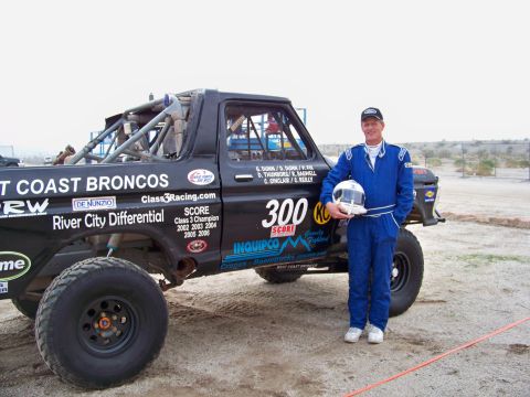 1994 Ford Bronco - A racer poses with his modified Ford Bronco, prepared for off-road competition.