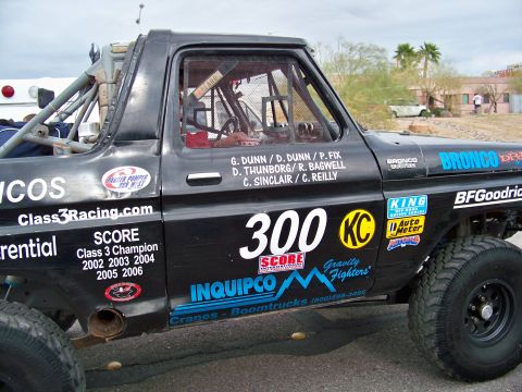 1994 Ford Bronco - This black off-road race truck features a prominent "300" graphic and extensive sponsor decals.