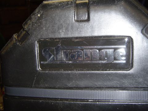 1989 Ford Bronco - Close-up of a black case with chrome lettering that spells "Strange".