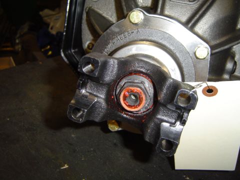 1989 Ford Bronco - A close-up view of a vehicle's driveshaft universal joint, showing a part number and grease application.