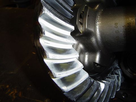 1989 Ford Bronco - Close-up of a differential gear showing teeth with marking compound and a stamped date code.