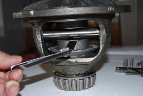 1996 Ford Bronco - A mechanic uses a tool to measure the internal components of a differential carrier.