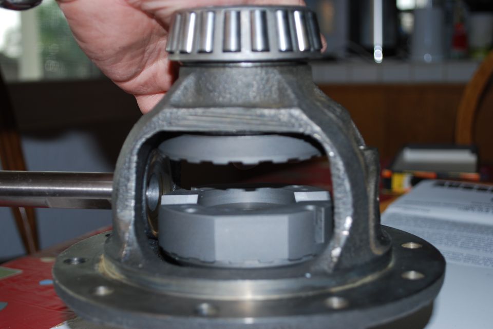 Differential carrier with bearing and gear teeth, held by a hand