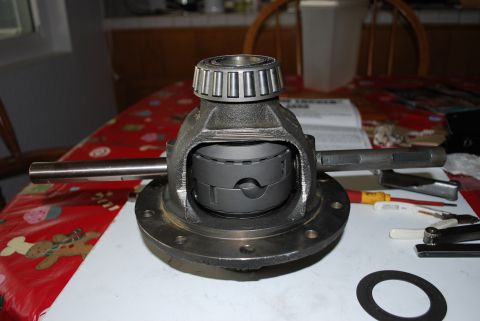1996 Ford Bronco - A differential carrier assembly, likely for a vehicle's drivetrain, is shown on a table with tools.
