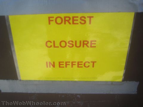 1990 Ford Bronco - Photo of a yellow Forest Closure In Effect notice sign, not a classifiable technical document.