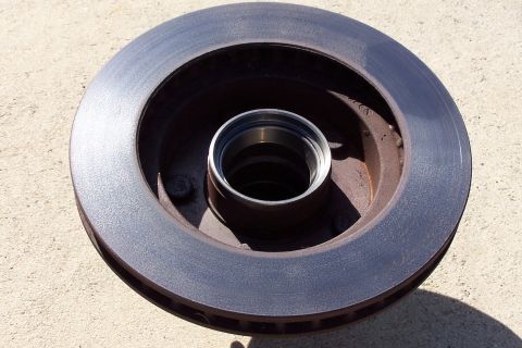 1990 Ford Bronco - A single brake rotor with a bearing is shown, isolated from any vehicle.