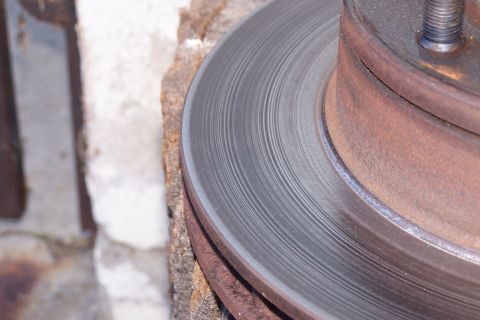1990 Ford Bronco - A close-up view of a worn brake rotor, showing concentric scoring from use.